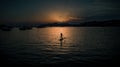 Silhouette of alone paddleboarder sailing into the evening sunset in Majorca, Spain Royalty Free Stock Photo