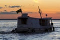 Silhouette of Amazon wooden boat on Rio Negro in Manaus, Brazil