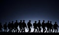 a silhouette of american soldiers marching in formation, with the full moon in the foreground