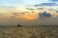 Silhouette of an anchor handling tug boat at oil field during sunrise