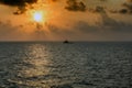 Silhouette of an anchor handling tug boat at oil field during sunrise