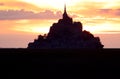 Silhouette of the ancient Abbey of Mont Saint Michel in the Normandy region of Northern France at sunset Royalty Free Stock Photo