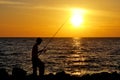 Silhouette of angler fishing on the rock at the beach of malacca