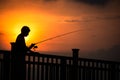 Silhouette of angler during sunset