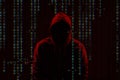 Silhouette of anonymous hacker and digital binary code on dark background. Cyber attack concept Royalty Free Stock Photo