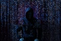 Silhouette of anonymous hacker and digital binary code on dark background. Cyber attack concept Royalty Free Stock Photo