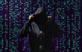 Silhouette of anonymous hacker and digital binary code on dark background. Cyber attack concept Royalty Free Stock Photo