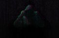 Silhouette of anonymous hacker and digital binary code on dark background. Cyber attack concept Royalty Free Stock Photo