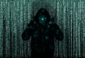 Silhouette of anonymous hacker and digital binary code on dark background. Cyber attack concept Royalty Free Stock Photo