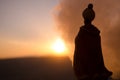 Silhouette of Arab man stands alone in the desert and watching the sunset with clouds of fog. Eastern Fairytale Royalty Free Stock Photo