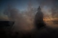 Silhouette of Arab man stands alone in the desert and watching the sunset with clouds of fog. Eastern Fairytale Royalty Free Stock Photo