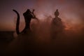 Silhouette of Arab man stands alone in the desert and watching the sunset with clouds of fog. Eastern Fairytale Royalty Free Stock Photo