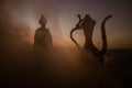 Silhouette of Arab man stands alone in the desert and watching the sunset with clouds of fog. Eastern Fairytale Royalty Free Stock Photo