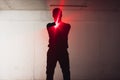 Silhouette of an armed man holding his gun and pointing with his laser beam at a target Royalty Free Stock Photo