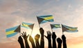 Silhouette of arms raised waving a Bahamas flag with pride. 3D Rendering