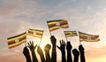 Silhouette of arms raised waving a Uganda flag with pride. 3D Rendering