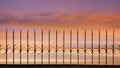 Silhouette arrow spiky metal fence against beautiful sunset sky background