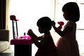 Silhouette Asian Chinese Liitle Sisters Playing With Make-Up Toy