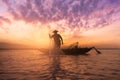 Silhouette asian fisherman holding a net for catching fish