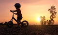 Silhouette Asian kid first day play balance bike. Royalty Free Stock Photo