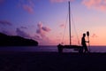 Silhouette asian man with paddle and sailing catamaran on the beach Royalty Free Stock Photo