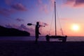 Silhouette asian man with paddle and sailing catamaran on the beach Royalty Free Stock Photo