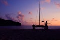 Silhouette asian man with paddle and sailing catamaran on the beach Royalty Free Stock Photo