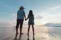 Silhouette of asian mother and daughter holding hand together standing on the beach looking at the beautiful sea and sky Royalty Free Stock Photo