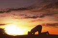 Silhouette asian muslim man with cap praying to god Royalty Free Stock Photo