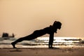 Silhouette of Asian woman practice yoga Plank or Phalakasana Pose on the sand and beach with sunset beautiful sea in Tropical isla Royalty Free Stock Photo