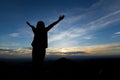 Silhouette of asian woman raise her arms looking at the mountain and enjoy with beautiful nature