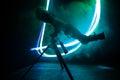 Silhouette of a astronomy telescope on dark foggy backlight