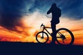 Silhouette of athlete bicyclist riding the bike on a rocky trail Royalty Free Stock Photo