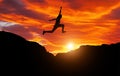 Silhouette of athlete, jumping over rocks in mountain area