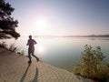 Silhouette of athlete run on sunset background copy space