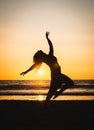 Silhouette of a happy beautiful dancer girl at sunset Royalty Free Stock Photo