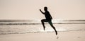 silhouette of athletic man runner running on summer beach, jogging Royalty Free Stock Photo