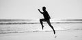 silhouette of athletic man runner running on summer beach, jogging Royalty Free Stock Photo