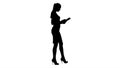 Silhouette Attractive businesswoman using a digital tablet while walking.