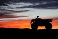 Silhouette ATV or Quad bike in the sunset. Holiday exploration concept