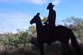 Silhouette of Australian farmer riding a horsde in the outbac