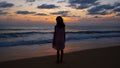 Silhouette of baby girl standing on beach looking the sunset or sunrise at the sea amazing light nature landscape background Royalty Free Stock Photo