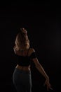 silhouette of the back of a dancing blonde woman Royalty Free Stock Photo