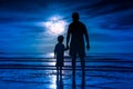 Silhouette of child holding hands her father, standing in the se Royalty Free Stock Photo