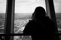 Silhouette Of Back View Of Woman Looking Out Of A Window At The