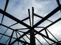 Silhouette background with blue sky, Structure of steel roof frame for building roof construction Royalty Free Stock Photo