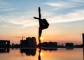 Silhouette of ballerina performing outdoor during sunset. Concept of willpower, motivation and desire