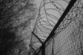 Silhouette of Barbed Wire fence against a Cloudy Sky Royalty Free Stock Photo