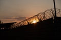 Silhouette of barbed wire fence with twilight sky. Barbed wire of restricted area Royalty Free Stock Photo