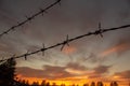 Silhouette of barbed wire on a sunset background, in a army camp , in PabradÃÂ¨ Royalty Free Stock Photo